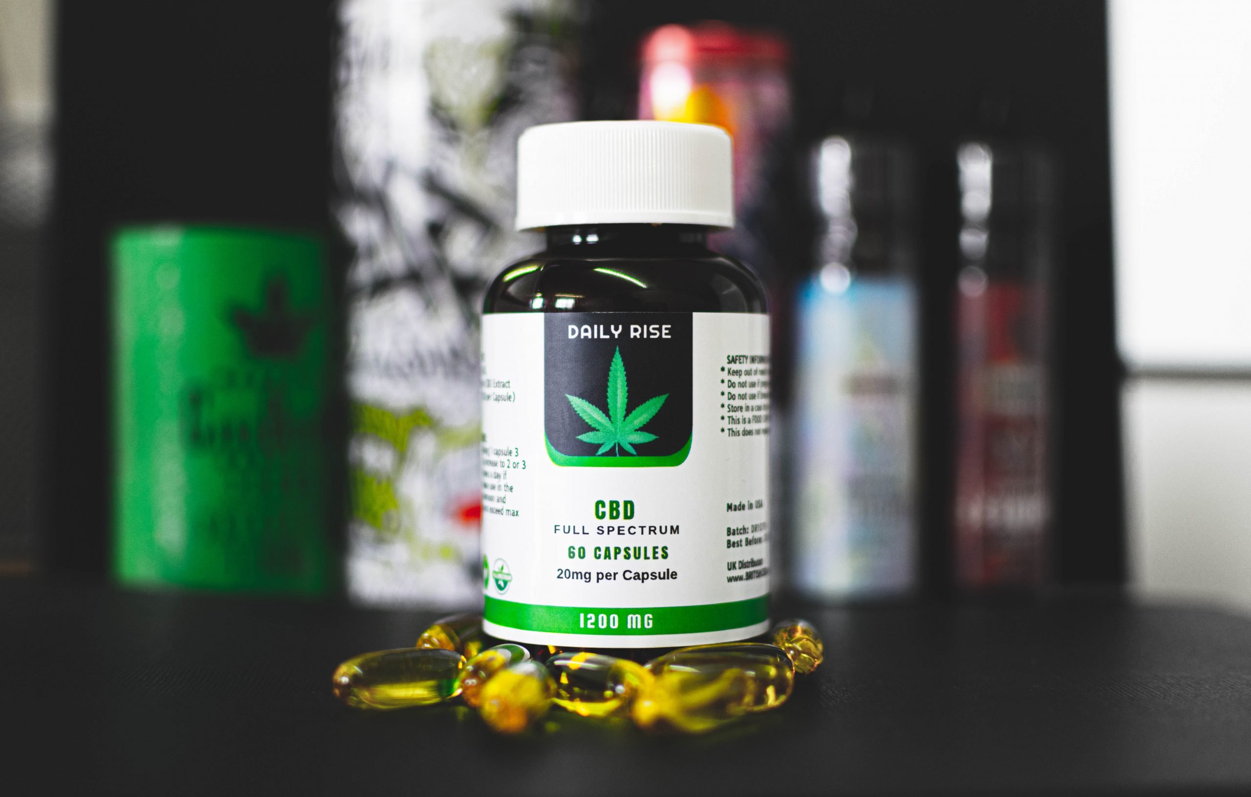 Daily Rise Full Spectrum Softgel CBD Capsules 1200mg on a dark background. Good for epilepsy, muscle pain, anxiety, and general pain relief